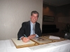 Steve Walske signing the Distinguished Philatelist Award book